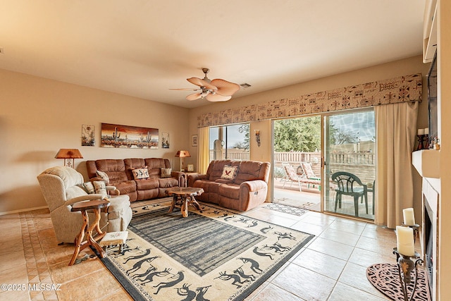 tiled living room featuring ceiling fan