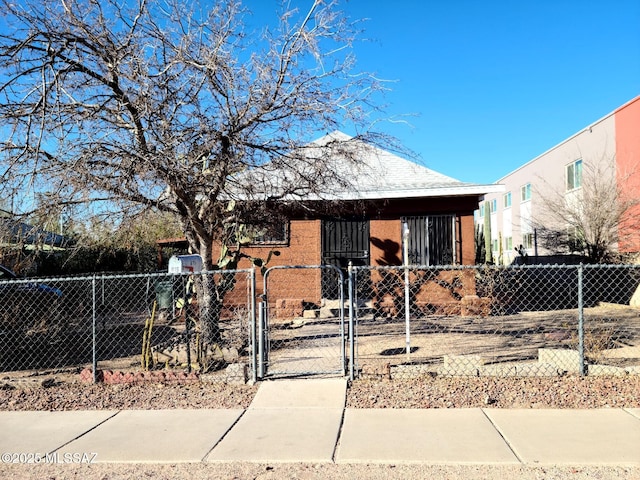 bungalow-style home with a fenced front yard and a gate