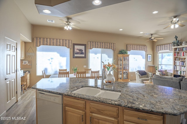 kitchen featuring visible vents, ceiling fan, a sink, dishwasher, and open floor plan