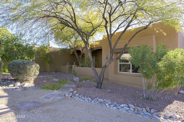 pueblo revival-style home featuring stucco siding