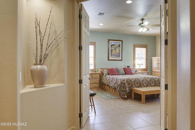bedroom featuring light tile patterned floors and visible vents