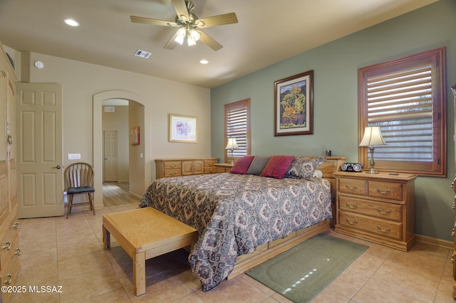 bedroom with light tile patterned floors, visible vents, baseboards, recessed lighting, and arched walkways