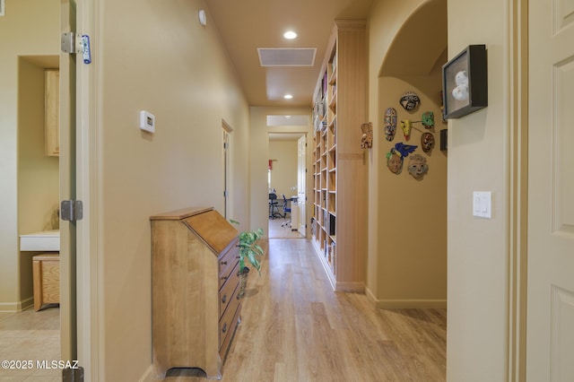 hallway with light wood-style flooring, recessed lighting, baseboards, and visible vents