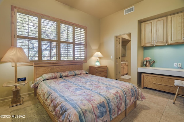 bedroom featuring light tile patterned floors, visible vents, ensuite bath, and baseboards