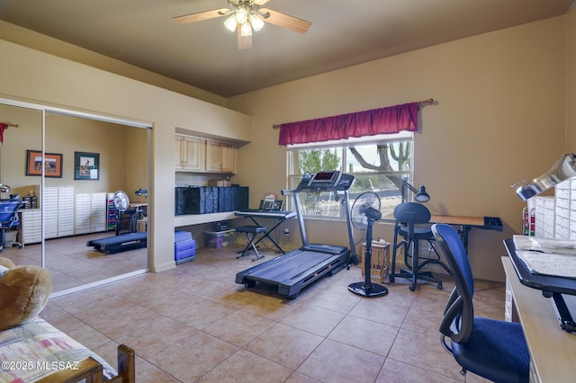 exercise area with light tile patterned floors and a ceiling fan