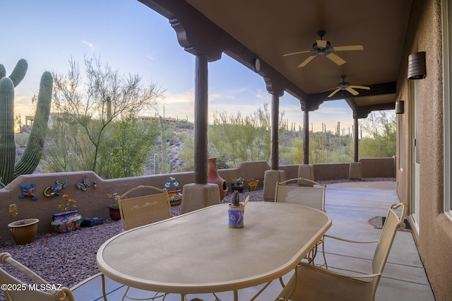 view of patio with outdoor dining area and a ceiling fan