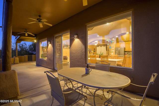 view of patio featuring ceiling fan and outdoor dining space