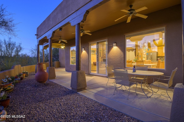 view of patio with outdoor dining space and fence