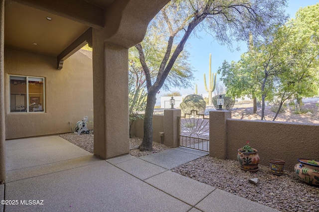 view of patio featuring a gate