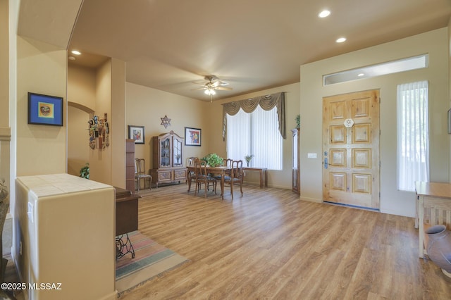 entrance foyer featuring arched walkways, recessed lighting, light wood-style floors, and a ceiling fan