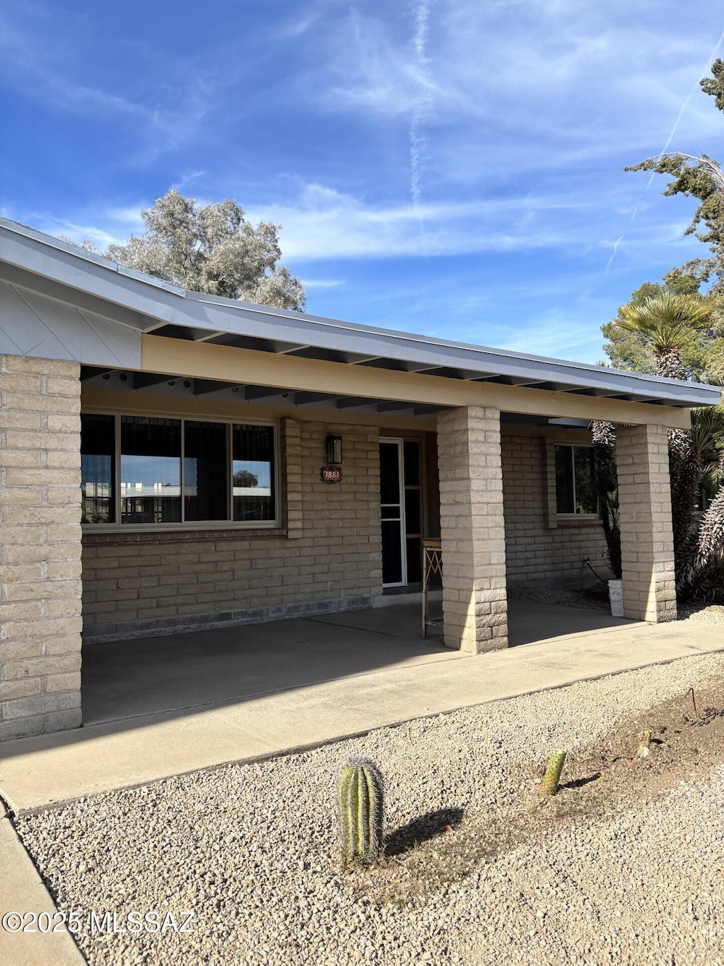 rear view of house featuring brick siding