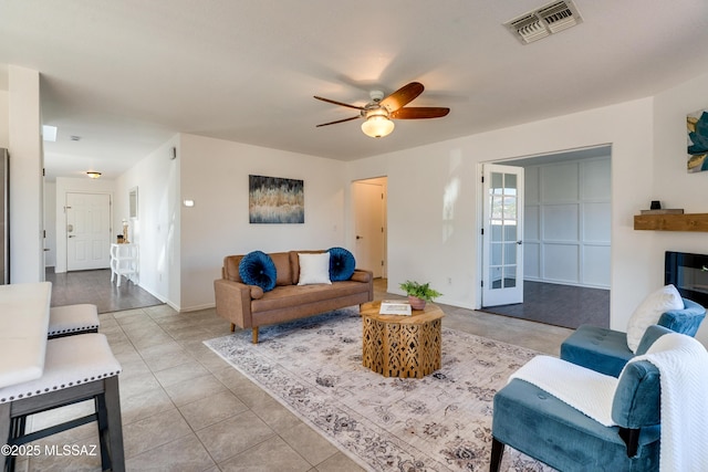 living room with light tile patterned floors and ceiling fan