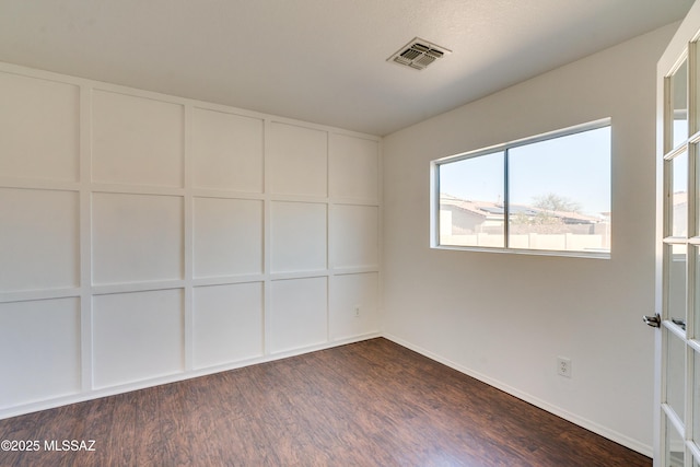 unfurnished room featuring dark wood-type flooring