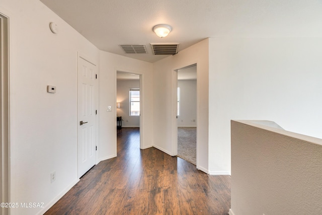 hall with dark hardwood / wood-style flooring