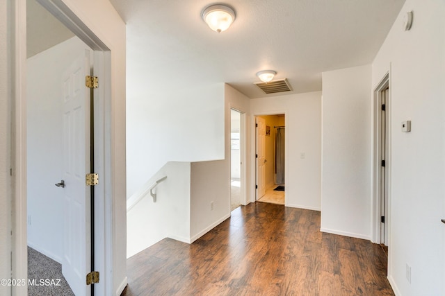 unfurnished room with dark wood-type flooring