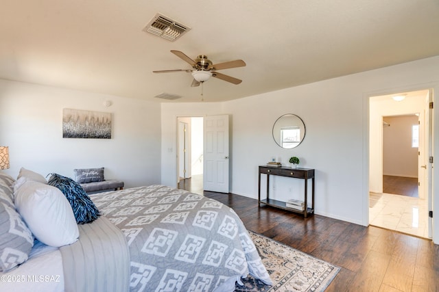 bedroom with dark hardwood / wood-style floors and ceiling fan