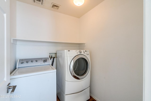 laundry room featuring washer and clothes dryer