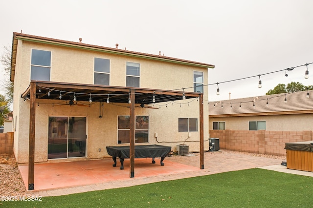 rear view of property featuring central AC unit, a patio area, and ceiling fan