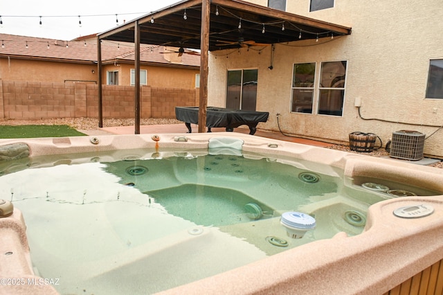 view of pool featuring cooling unit, a hot tub, and ceiling fan