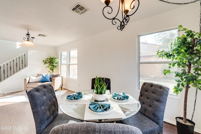 dining space featuring a notable chandelier and dark hardwood / wood-style floors