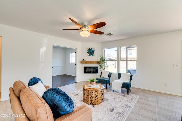 living room with ceiling fan and light tile patterned flooring