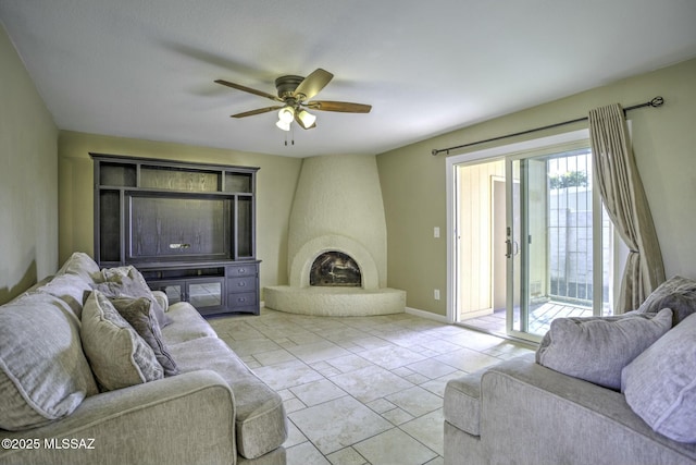 living room featuring ceiling fan and a fireplace