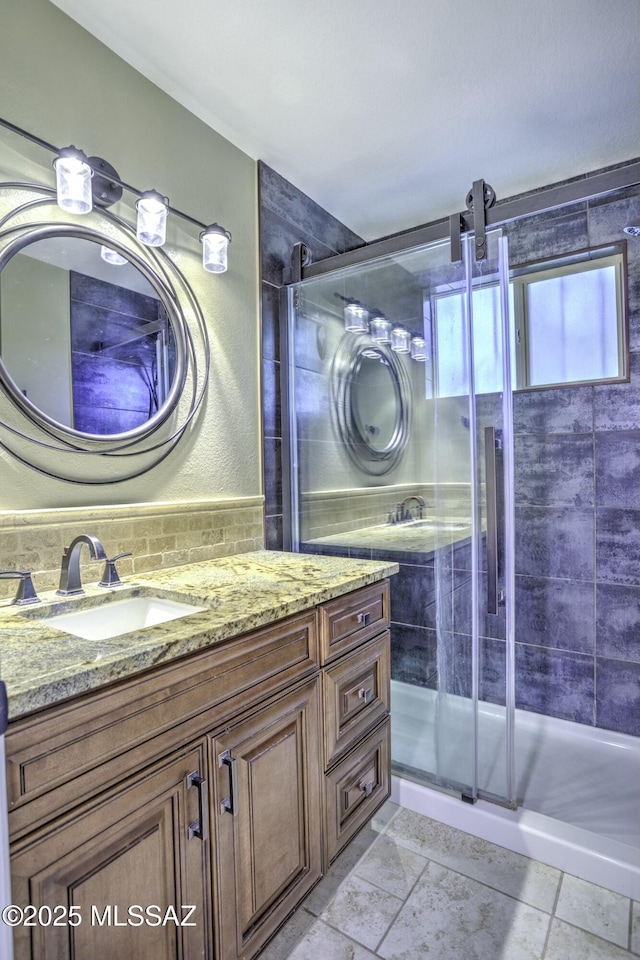 bathroom with vanity and a shower with shower door