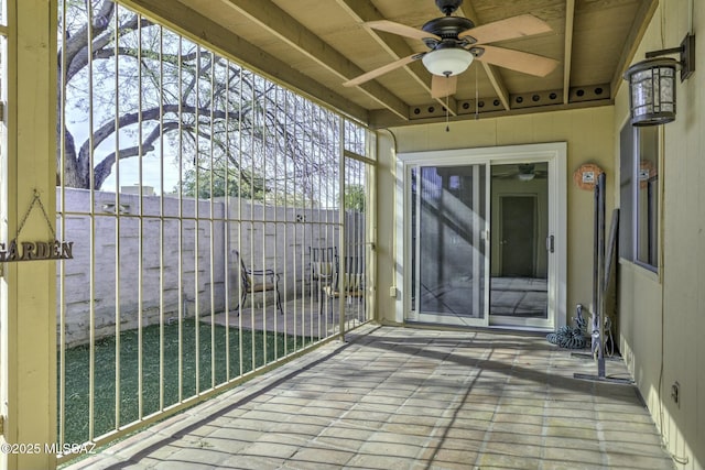 unfurnished sunroom featuring ceiling fan