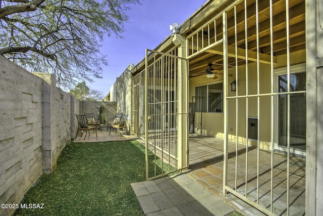 view of home's exterior with a patio and ceiling fan