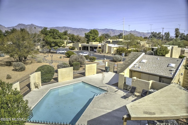 view of swimming pool with a mountain view