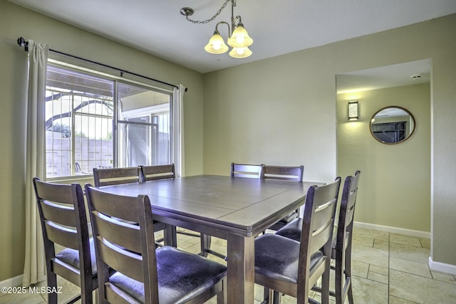 tiled dining area featuring an inviting chandelier