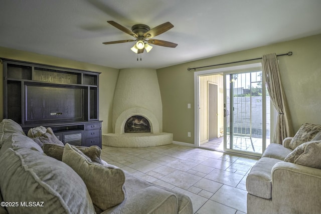 living room featuring a large fireplace, light tile patterned floors, and ceiling fan