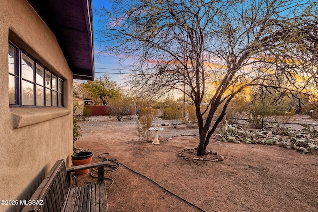 view of yard at dusk