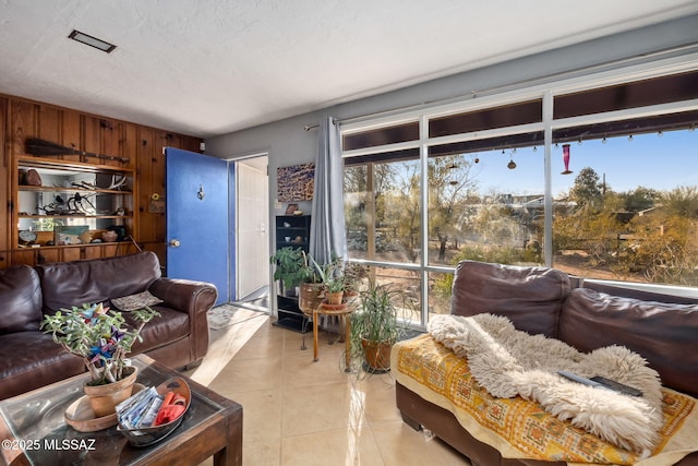 tiled living room with a textured ceiling