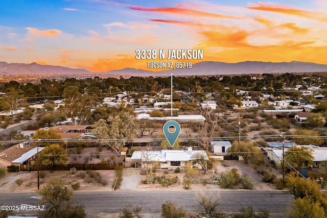 aerial view at dusk featuring a mountain view