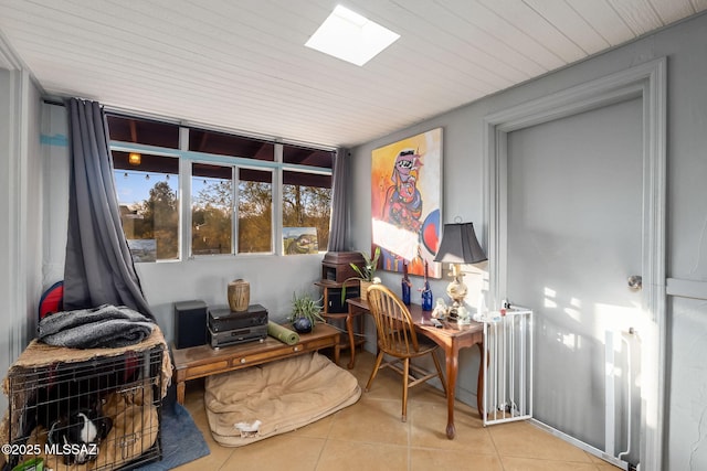 interior space with radiator heating unit, light tile patterned floors, wood ceiling, and a skylight