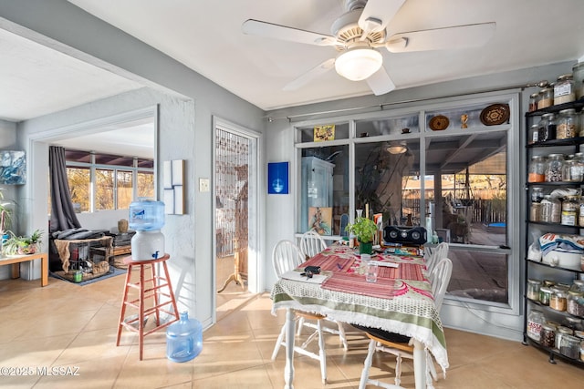 dining space featuring ceiling fan and tile patterned floors