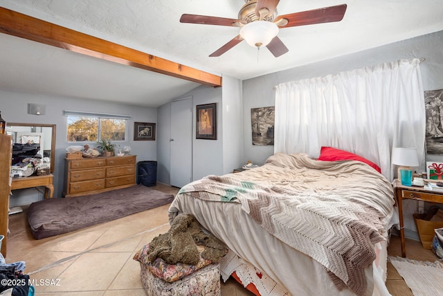 tiled bedroom with lofted ceiling with beams and ceiling fan