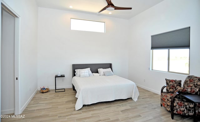 bedroom with ceiling fan and light hardwood / wood-style flooring