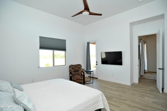 bedroom with ceiling fan and light hardwood / wood-style floors