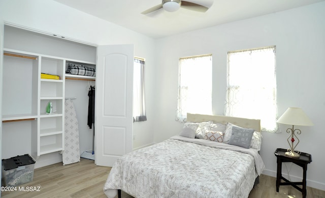 bedroom featuring a closet, ceiling fan, and light wood-type flooring