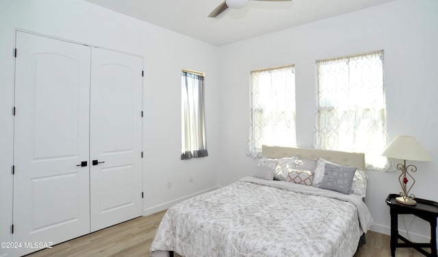 bedroom featuring light hardwood / wood-style floors, a closet, and ceiling fan