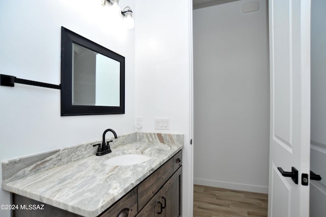 bathroom featuring hardwood / wood-style flooring and vanity