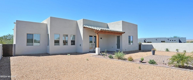 adobe home with a patio area