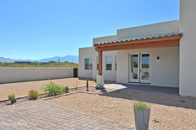 back of property featuring a patio and a mountain view