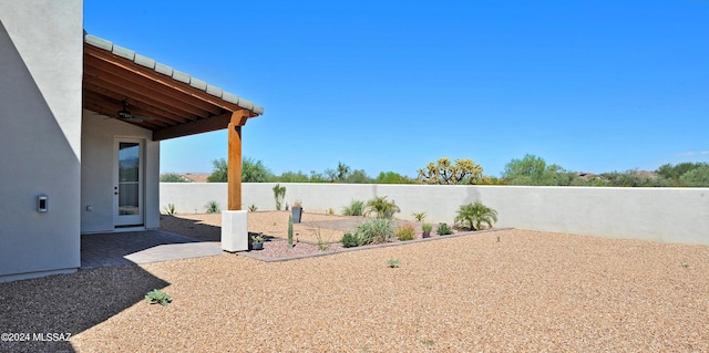 view of yard with a patio and ceiling fan