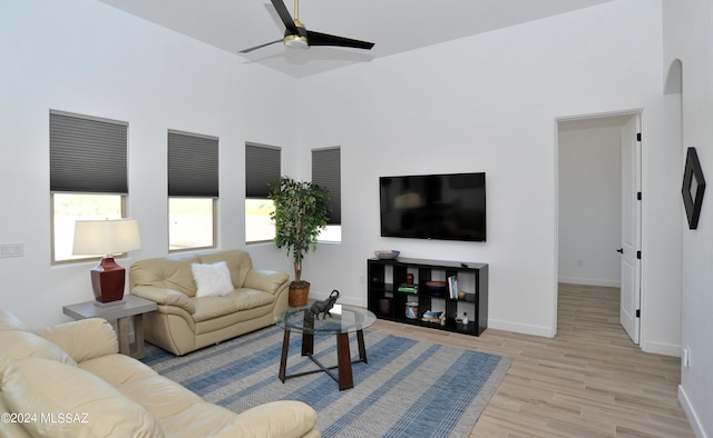 living room with ceiling fan and light hardwood / wood-style flooring