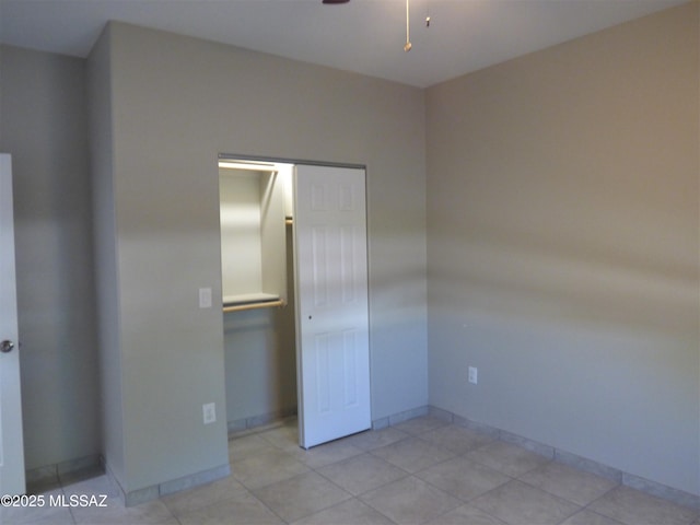 unfurnished bedroom with a closet and baseboards