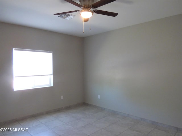 spare room with visible vents and a ceiling fan