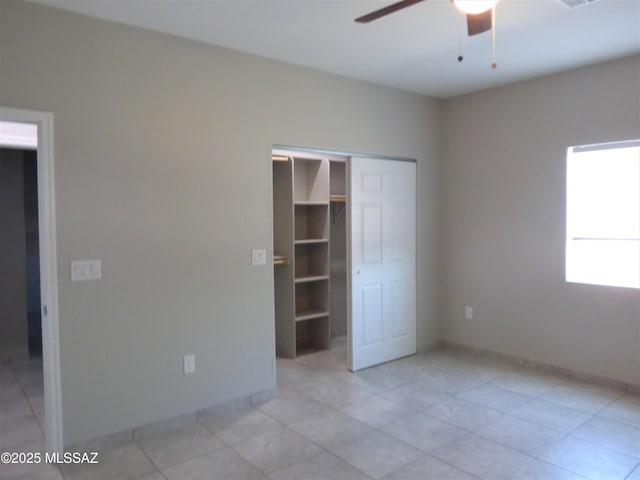 unfurnished bedroom with a ceiling fan, baseboards, and a closet